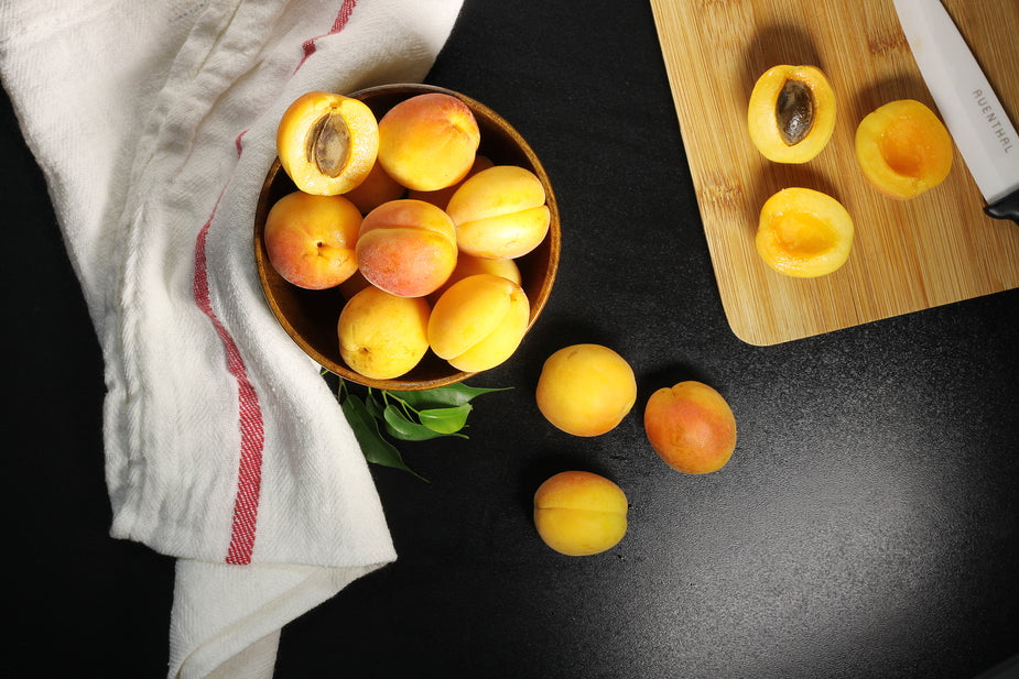 Apricots sliced open for a lovely presentation in a basket.