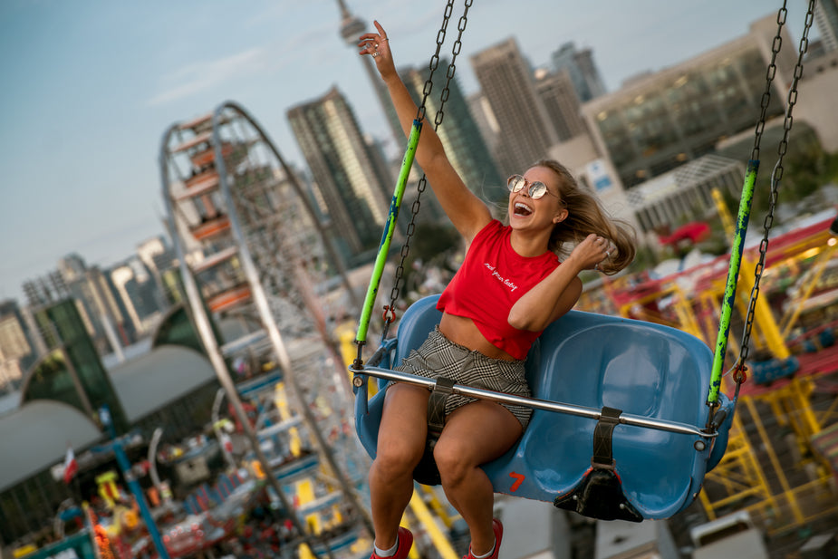 Woman pushing the fun to the limit as she enjoys a ride at the fair.