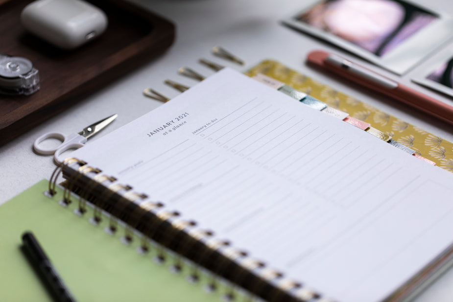 A close up of a 2021 planner opened to January, as someone prepares their new year plans.