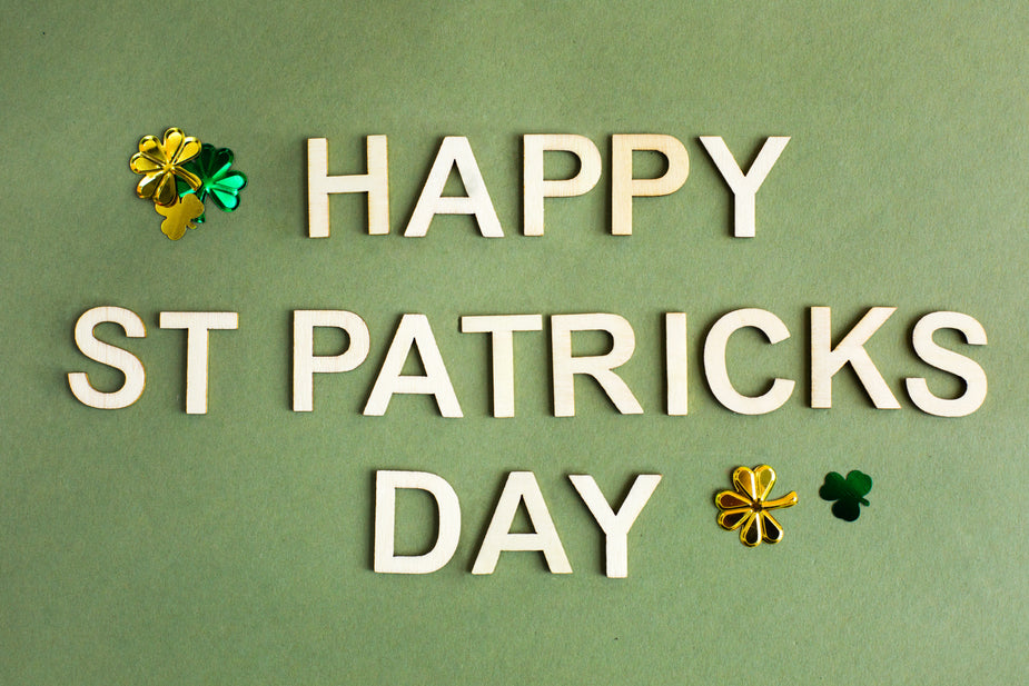 A green background with decorative clovers and the words "Happy St. Patricks Day" spelled out on top.