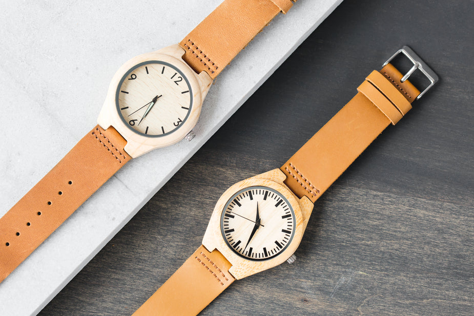 Wood and leather watches with numbers and without on dark and light background. dual tasking is not multitasking