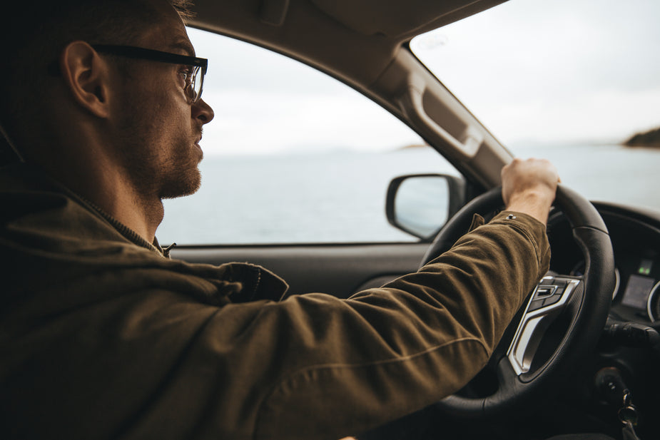 A person focusing on the task of driving. They are taking this offroad adventure very seriously. Good thing too! not multitasking