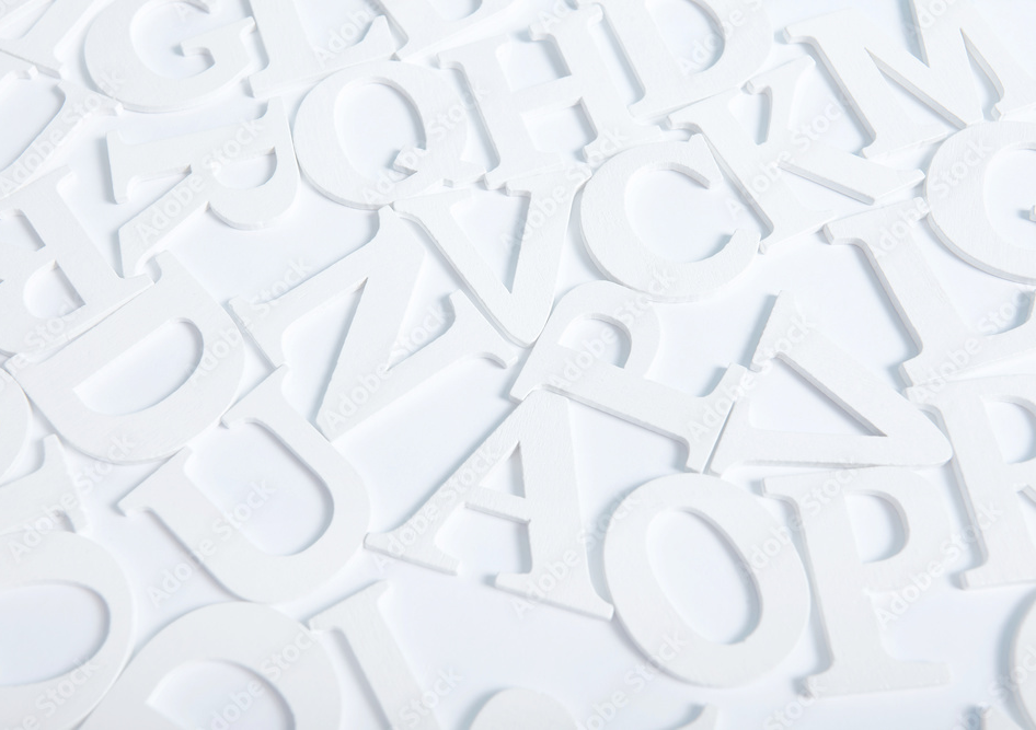 White wooden alphabet letters top view on white background